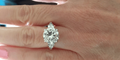 3 carat diamond in 3 stone setting on hand